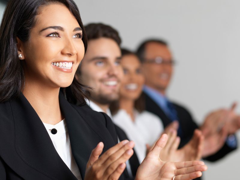 Happy people clapping at an event due to successful strategic event management
