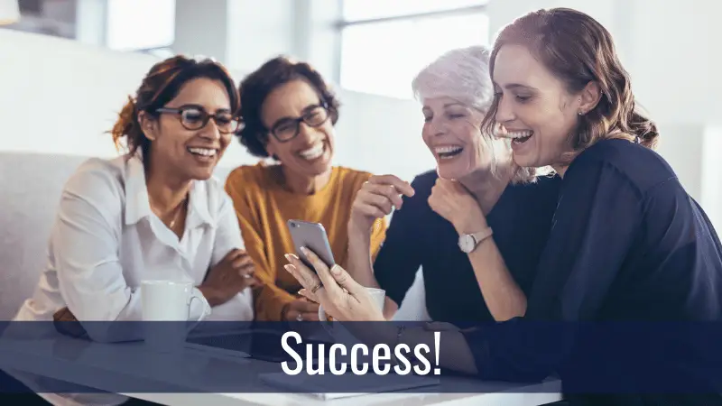 Group of professionals looking at a mobile phone